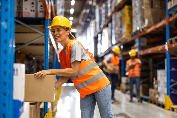 istock Female warehouse worker carries box 2159807878