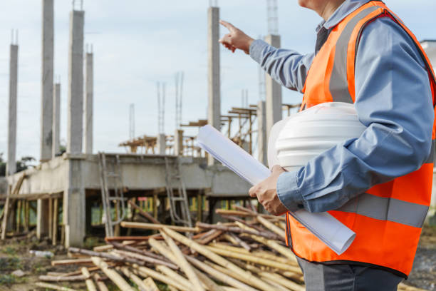 istock Male Asian construction contractor engineer checks structural plans, engineers concrete columns and beams of a new house. 2159808484
