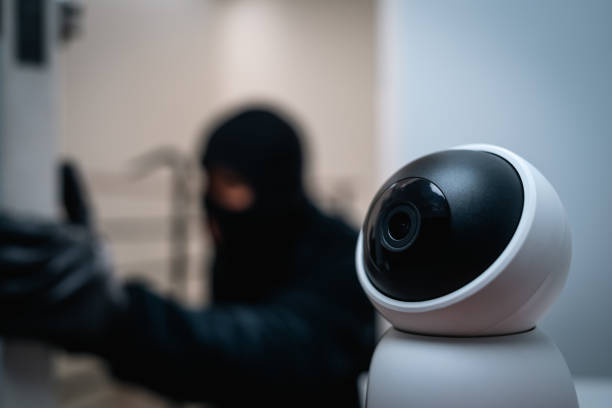istock Security camera.Thief in uniform black jacket various action housebreak. The Robber terrorism criminal escapes with balaclava and crowbar entering a house for stealing Housebreak at night 2159812385