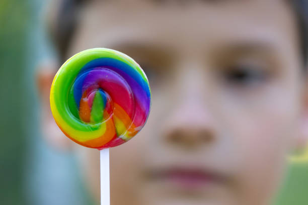 istock Boy is holding a bright spiral lollipop, summer vibes. 2159812518