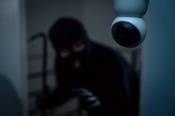 istock Security camera.Thief in uniform black jacket various action housebreak. The Robber terrorism criminal escapes with balaclava and crowbar entering a house for stealing Housebreak at night 2159813096