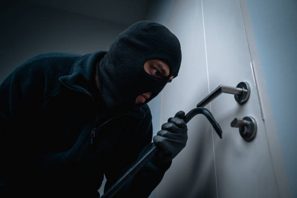 istock Thief in uniform black jacket various action housebreak. The Robber terrorism criminal escapes with balaclava and crowbar entering a house for stealing Housebreak at night 2159814238
