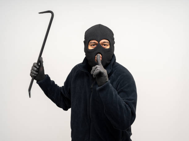 istock Thief in uniform black jacket various pose on isolated background. The Robber terrorism criminal escapes with balaclava and crowbar entering a house for stealing Housebreak 2159814712