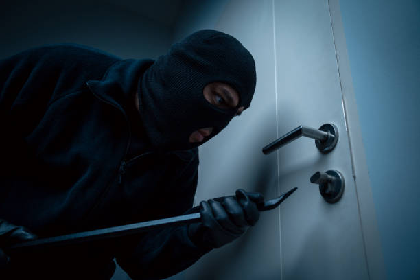 istock Thief in uniform black jacket various action housebreak. The Robber terrorism criminal escapes with balaclava and crowbar entering a house for stealing Housebreak at night 2159814732