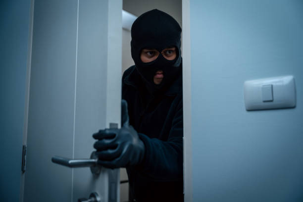 istock Thief in uniform black jacket various action housebreak. The Robber terrorism criminal escapes with balaclava and crowbar entering a house for stealing Housebreak at night 2159815285