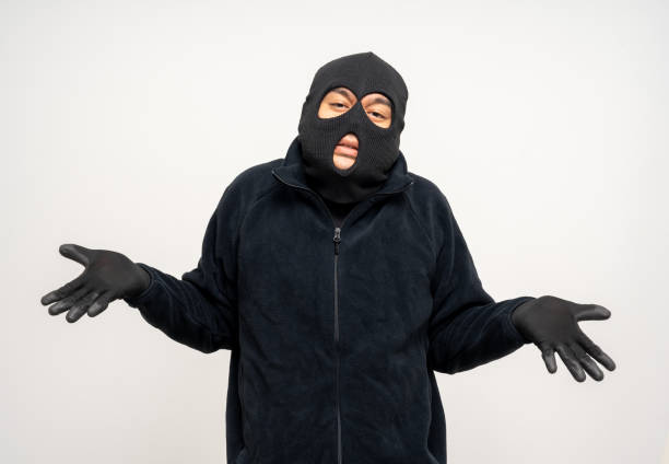 istock Thief in uniform black jacket various pose on isolated background. The Robber terrorism criminal escapes with balaclava and crowbar entering a house for stealing Housebreak 2159815563