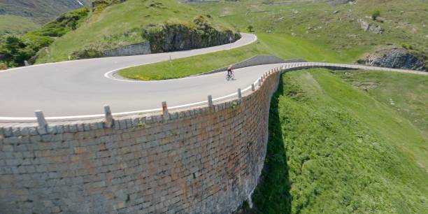 istock Road biker rides up high mountain pass in springtime 2159816077