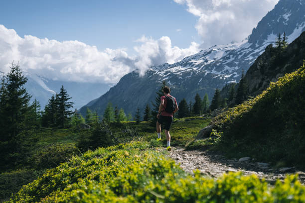 istock Trail runner bounds along mountain trail 2159816115