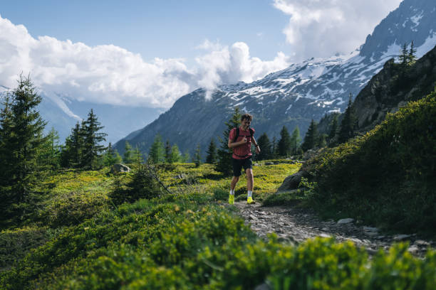 istock Trail runner bounds along mountain trail 2159816121