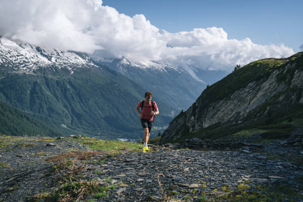 istock Trail runner bounds along mountain trail 2159816142