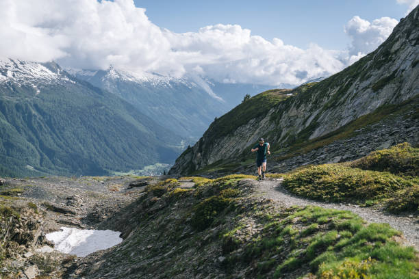 istock Trail runner bounds along mountain trail 2159816146