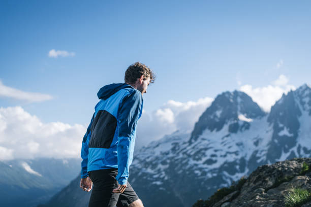 istock Trail runner bounds along mountain trail 2159816162