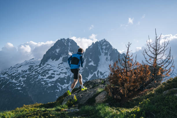 istock Trail runner bounds along mountain trail 2159816163