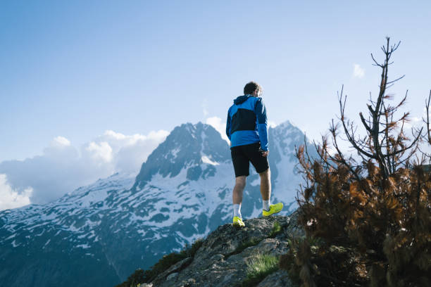 istock Trail runner bounds along mountain trail 2159816187