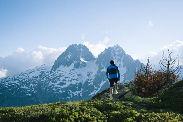 istock Trail runner bounds along mountain trail 2159816188