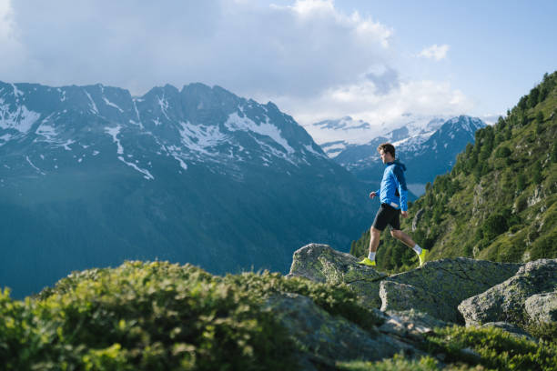 istock Trail runner bounds along mountain trail 2159816213