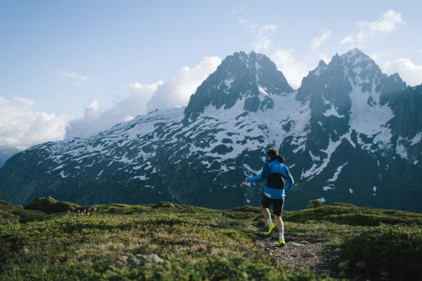 istock Trail runner bounds along mountain trail 2159816232