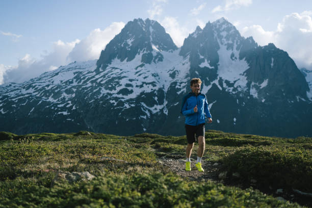 istock Trail runner bounds along mountain trail 2159816233