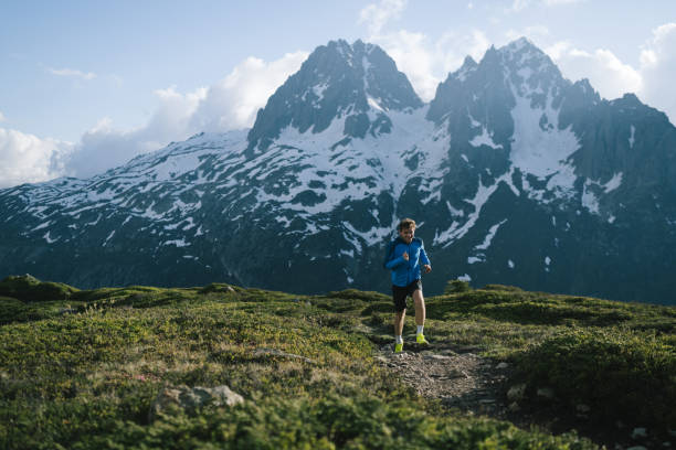 istock Trail runner bounds along mountain trail 2159816257
