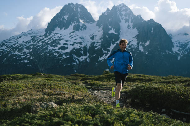 istock Trail runner bounds along mountain trail 2159816260