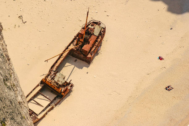 Storm's Aftermath: Iron Boat Stranded on Ferragudo Coastline, Algarve.