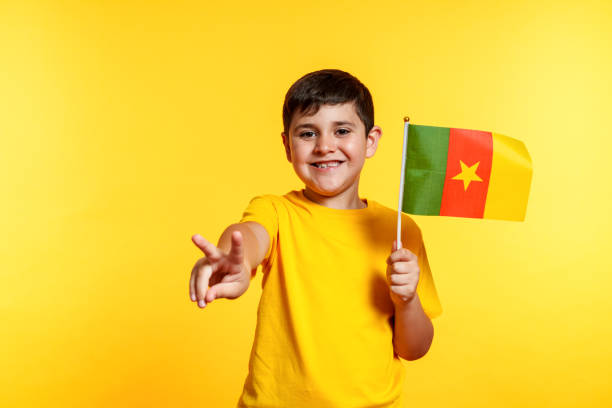 istock A young boy is holding a Cameroon flag and smiling 2159820828