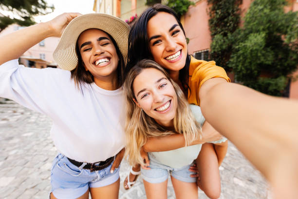 istock Diverse group of three happy young women having fun on summer vacation 2159823334