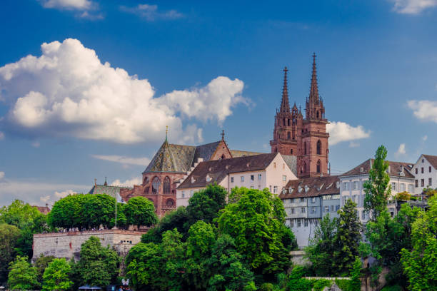 Basel city with a large church and a castle. The sky is blue and there are some clouds