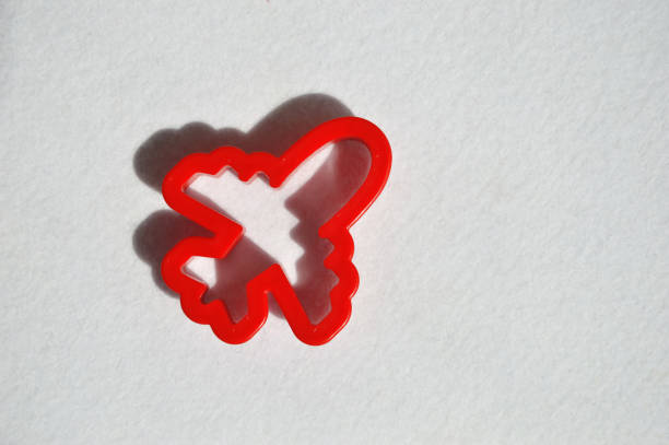 A cute red toy airplane is flying into the sky. a bright background for the design.