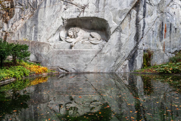 Lucerne, Switzerland - November 1, 2023: Lion of Lucerne in autumn season. The rock relief dates from 1821 and commemorates the Swiss Guards who were massacred in 1792 during the French Revolution.