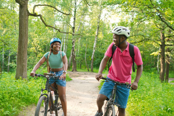 istock Young couple riding bicycle in summer park 2159829841