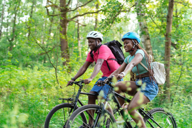 istock Young couple riding bicycle in summer park 2159831007