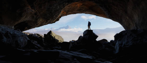 istock Adult adventurous man standing in a cave. 3d rendering mountain adventure artwork. 2159832383