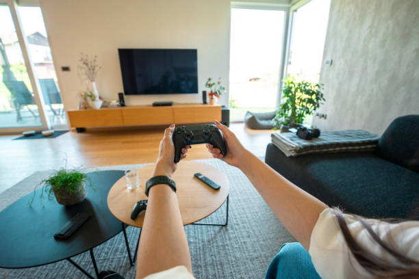 Man is playing video game on digital tablet using hand controller
