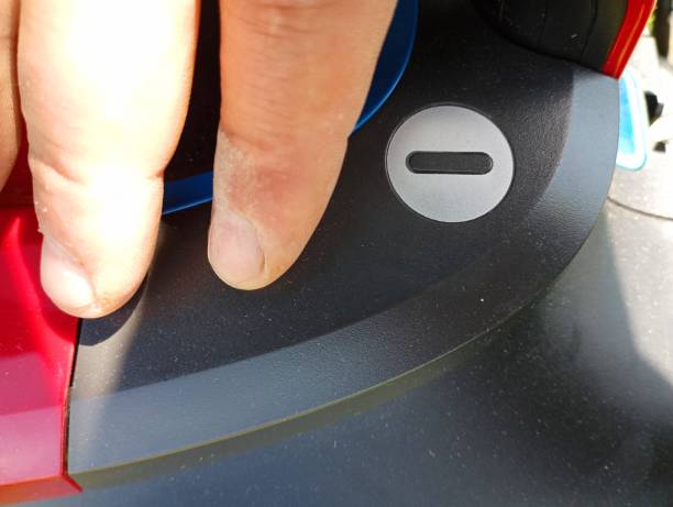 istock A person presses a plastic big black button to turn on an electrical appliance. 2159839624