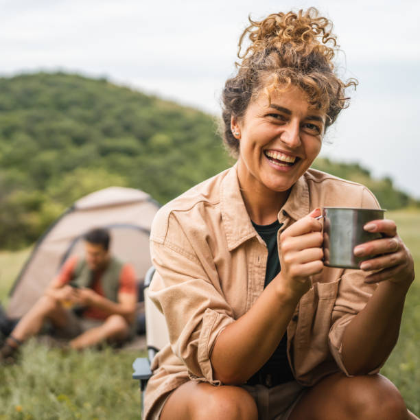 istock Girlfriend prepare coffee while camp with boyfriend in the background 2159843042