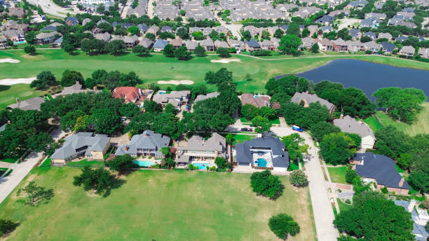 istock Small pond situated in upscale golf course community row of upscale large mansion houses with concrete tiles roof, swimming pool in East of Plano, Texas, Dallas Fort Worth metroplex, aerial view 2159846755