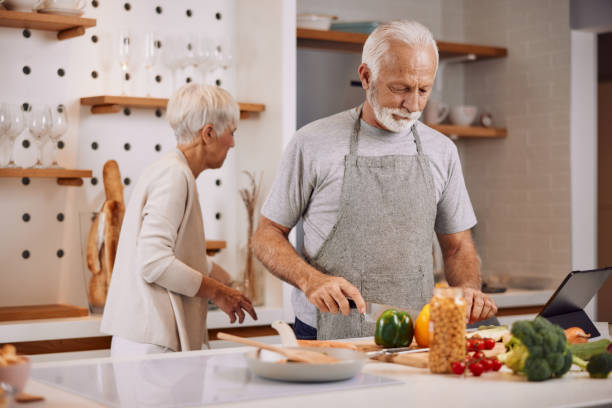istock a happy senior couple preparing a healthy meal together, using a tablet 2159848957