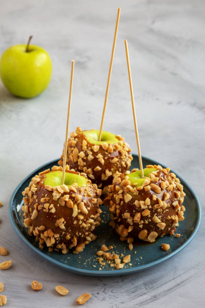 istock Homemade Halloween Candy Taffy Apples on a Plate, side view. 2159850231