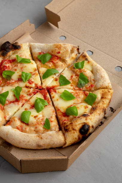 istock Organic Margarita Pizza with Basil and Mozarella in a Box, side view. 2159851747
