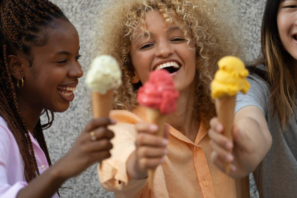 istock Three happy multiethnic friends welcome summer holding an icecream 2159852030