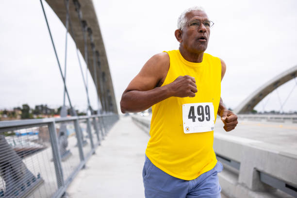 istock Senior black man running in a marathon 2159855432