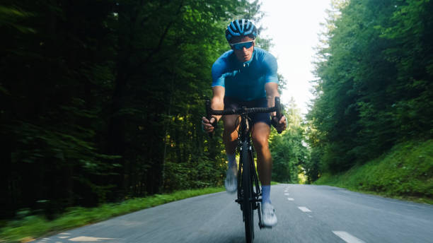 istock Man racing cyclist in a sprint cycling pose 2159855436