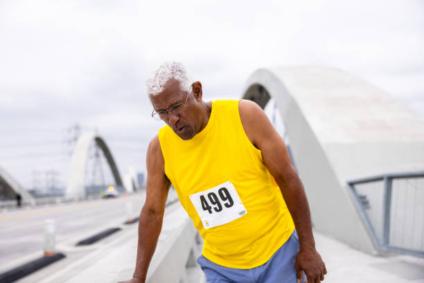 istock Senior black man running in a marathon 2159855486