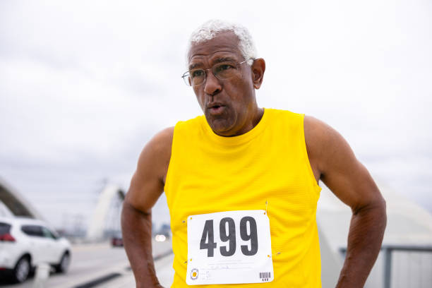istock Senior black man running in a marathon 2159855517
