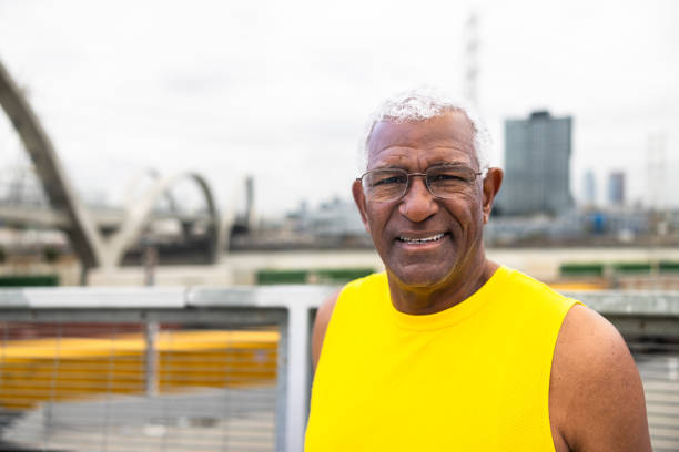 Portrait of a self-assured mature man standing sideways with arms crossed