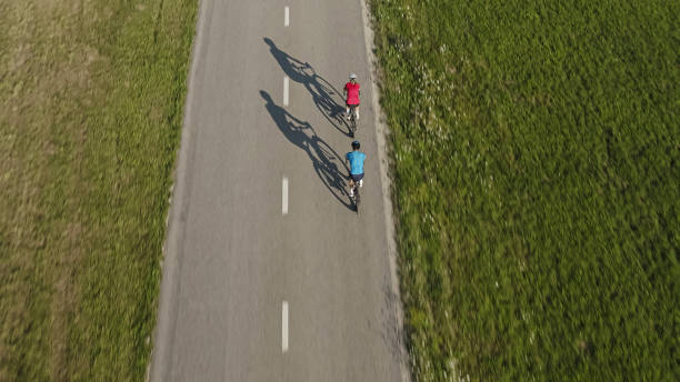 istock Two people cycling road bikes 2159855637