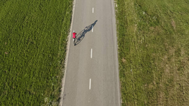 istock Female racing cycle rider pedaling 2159855752