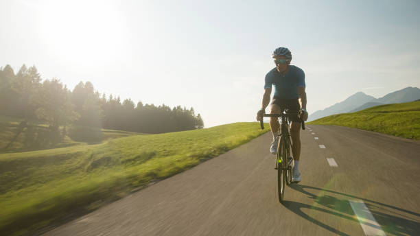 istock Man racing cyclist in a sprint cycling pose 2159855859