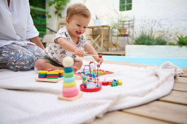 istock Smiling baby playing with educational toys outdoors on a sunny day 2159857685